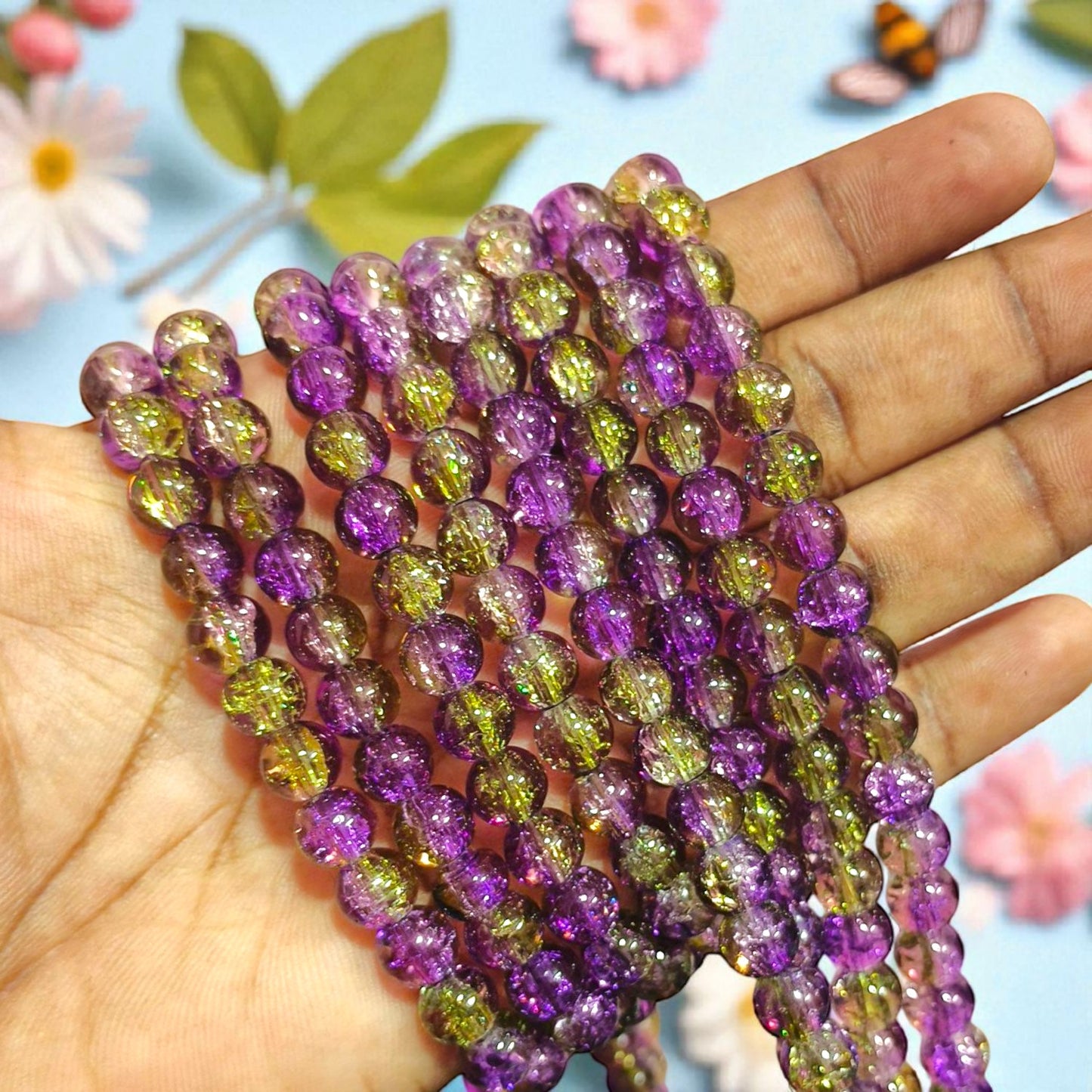 Round 8 mm crackle beads in purple with green accents, semi-transparent with internal crackled texture