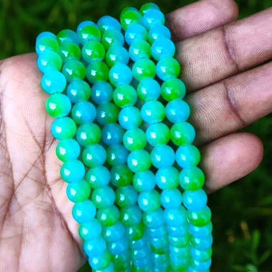 Glossy jelly beads in deep green and blue hues, adding a vibrant, glass-like effect to handmade accessories.