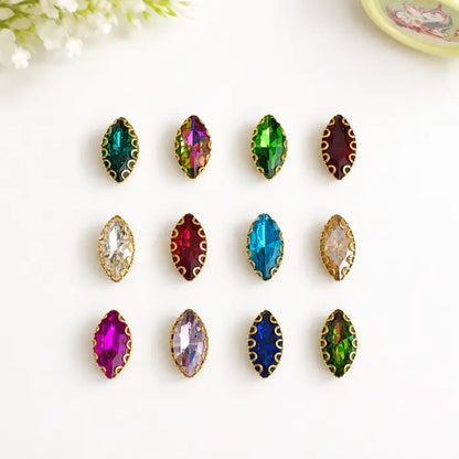 Eye Shape Clip Stone with faceted surface and gold-tone border in assorted colours