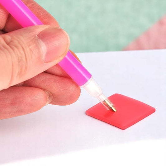 Fine-tip glue pen designed for detailed jewelry work, perfect for attaching rhinestones, cabochons, and other small embellishments.