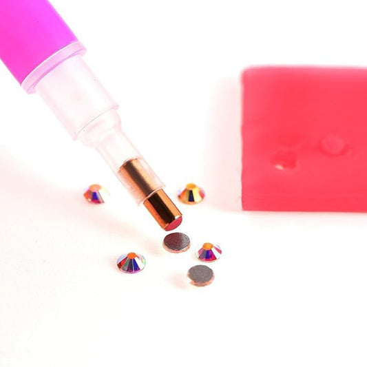 Fine-tip glue pen designed for detailed jewelry work, perfect for attaching rhinestones, cabochons, and other small embellishments.