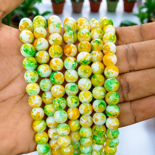 Green and yellow printed beads for jewelry making and DIY crafts