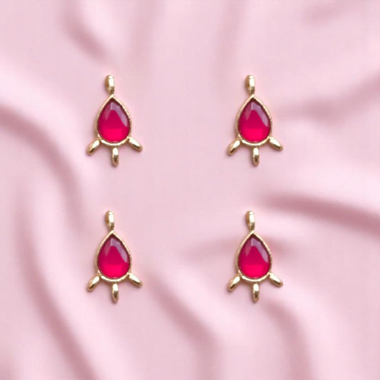 Elegant red-colored Kundan drop connectors with teardrop shapes and metallic gold frames, perfect for linking elements in necklaces, earrings.