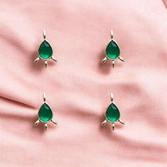 Elegant green teardrop Kundan connectors set in gold borders, perfect for linking components in necklaces, earrings, or festive accessories.