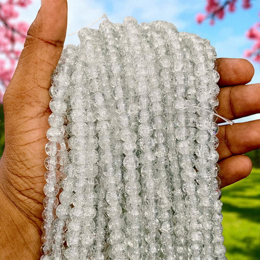 Light ash crackle beads with a subtle crackled texture, ideal for jewelry making and craft designs.