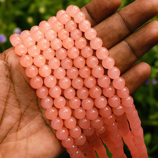 Light peach jelly beads with a translucent, glossy finish, perfect for jewelry making and crafts.
