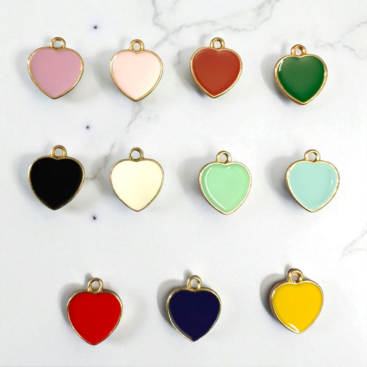 Shiny heart-shaped charms with a glossy finish, perfect for DIY jewelry, bracelets, and craft embellishments