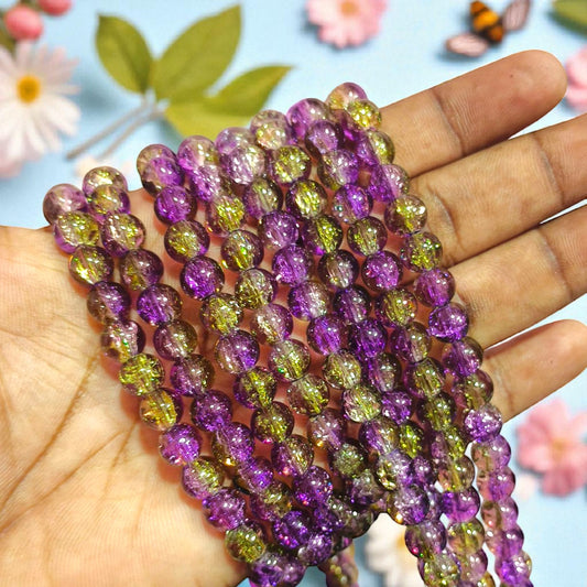 Round 8 mm crackle beads in purple with green accents, semi-transparent with internal crackled texture