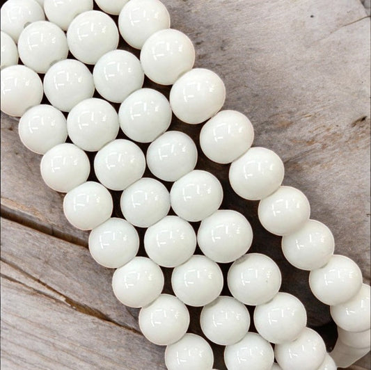 Smooth 8mm white glass bead with a shiny, polished finish, ideal for bracelets, necklaces, and elegant DIY jewelry designs.